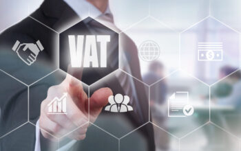 Businessman pressing a VAT concept button.